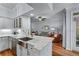 Open concept kitchen with marble countertops, stainless steel sink, and view to the living room at 3777 Peachtree Ne Rd # 1313, Brookhaven, GA 30319