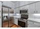 Modern kitchen featuring stainless steel appliances, white cabinets, and marble countertops at 3777 Peachtree Ne Rd # 1313, Brookhaven, GA 30319