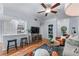 Inviting living room featuring hardwood floors, a ceiling fan, stylish furniture, and an open view to the kitchen at 3777 Peachtree Ne Rd # 1313, Brookhaven, GA 30319