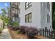 A white brick apartment exterior with black trim, balcony, and green shrubs at 68 Peachtree Memorial Nw Dr # 68-1, Atlanta, GA 30309