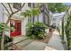 Charming building entrance with a red front door and landscaped walkway at 68 Peachtree Memorial Nw Dr # 68-1, Atlanta, GA 30309