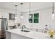 Contemporary kitchen featuring a stainless steel refrigerator, gas range, and white cabinetry at 68 Peachtree Memorial Nw Dr # 68-1, Atlanta, GA 30309