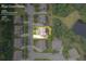 Aerial view of the home on a .25 acre lot, surrounded by lush greenery in a suburban neighborhood at 8920 Ellesmere Dr, Cumming, GA 30041