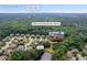 Aerial view of the neighborhood with mature trees; near Daves Creek Elementary School and Lake Lanier at 8920 Ellesmere Dr, Cumming, GA 30041