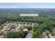Aerial view of the neighborhood with mature trees; near Daves Creek Elementary School and Lake Lanier at 8920 Ellesmere Dr, Cumming, GA 30041