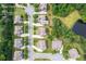 Aerial view of the home on a .25 acre lot, surrounded by lush greenery in a suburban neighborhood at 8920 Ellesmere Dr, Cumming, GA 30041