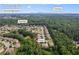 Aerial view of the neighborhood in Cumming, GA near S Forsyth High School with lush greenery at 8920 Ellesmere Dr, Cumming, GA 30041