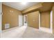 Basement space with painted walls and carpet flooring with access to unfinished space at 8920 Ellesmere Dr, Cumming, GA 30041