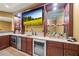 Finished basement wet bar with wooden cabinetry, sink, small refrigerator, granite countertops, and shelving at 8920 Ellesmere Dr, Cumming, GA 30041