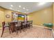 Basement wet bar area with a wood paneled bar, sink, cabinetry and barstool seating at 8920 Ellesmere Dr, Cumming, GA 30041