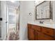 Bathroom with wood vanity, white countertops, and patterned framed mirror at 8920 Ellesmere Dr, Cumming, GA 30041