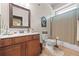 Bathroom with tan-colored tile flooring, vanity with sink, toilet, and shower/tub combo at 8920 Ellesmere Dr, Cumming, GA 30041