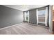 Bedroom with gray walls, neutral carpet, and an abundance of natural light from large windows at 8920 Ellesmere Dr, Cumming, GA 30041