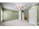 A carpeted bedroom showing two doorways and natural light at 8920 Ellesmere Dr, Cumming, GA 30041