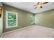 An empty bedroom with leafy views visible through window at 8920 Ellesmere Dr, Cumming, GA 30041
