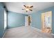 Bedroom featuring blue walls, carpeted floors, and multiple entry doors at 8920 Ellesmere Dr, Cumming, GA 30041
