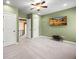 Carpeted bedroom with tv and doorways leading to other rooms at 8920 Ellesmere Dr, Cumming, GA 30041