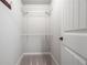 A walk in closet showing a metal shelving unit and carpet flooring at 8920 Ellesmere Dr, Cumming, GA 30041