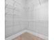 Unfinished walk-in closet with wire rack shelving at 8920 Ellesmere Dr, Cumming, GA 30041
