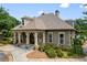 Charming clubhouse with stone accents, covered entry, and well-maintained landscaping at 8920 Ellesmere Dr, Cumming, GA 30041