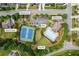 Aerial view showcases the community amenities, including a pool, tennis courts, playground and clubhouse at 8920 Ellesmere Dr, Cumming, GA 30041