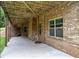 View of the covered patio with brick pillars, perfect for entertaining at 8920 Ellesmere Dr, Cumming, GA 30041