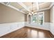 Formal dining room with coffered ceiling, chandelier, and natural light at 8920 Ellesmere Dr, Cumming, GA 30041