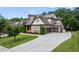Beautiful home with a spacious driveway leading to a two-car garage and a basketball hoop for outdoor recreation at 8920 Ellesmere Dr, Cumming, GA 30041