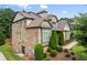 Well-maintained home with a side entry door, a two-car garage and mature landscaping on a desirable lot at 8920 Ellesmere Dr, Cumming, GA 30041