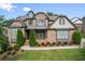 Charming brick home with manicured lawn, tasteful landscaping, and inviting front entry offers great curb appeal at 8920 Ellesmere Dr, Cumming, GA 30041