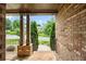 Charming front porch featuring brick columns and a black railing, perfect for enjoying the outdoors at 8920 Ellesmere Dr, Cumming, GA 30041