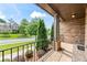 Cozy front porch with decorative columns and black railing offers a relaxing outdoor space to enjoy the neighborhood view at 8920 Ellesmere Dr, Cumming, GA 30041