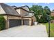 Spacious two car garage featuring ample driveway space, additional storage and an exterior basketball hoop at 8920 Ellesmere Dr, Cumming, GA 30041