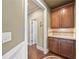 Hallway with hardwood floors, and dark wood cabinets with granite counters at 8920 Ellesmere Dr, Cumming, GA 30041