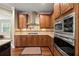 Gourmet kitchen featuring stainless appliances, custom cabinets, granite countertops, and gas cooktop at 8920 Ellesmere Dr, Cumming, GA 30041