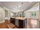 Gourmet kitchen features a large center island with granite countertops and stainless steel dishwasher at 8920 Ellesmere Dr, Cumming, GA 30041