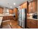 Gourmet kitchen with stainless steel refrigerator, custom cabinets, granite countertops, and stainless steel appliances at 8920 Ellesmere Dr, Cumming, GA 30041