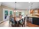 Eat in kitchen and dining room featuring granite countertops, stainless appliances, and backyard access at 8920 Ellesmere Dr, Cumming, GA 30041