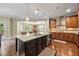 Gourmet kitchen features a center island, granite countertops, stainless appliances, and custom cabinets at 8920 Ellesmere Dr, Cumming, GA 30041