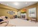 Finished basement featuring a stone fireplace with flat screen tv, multiple windows, and neutral carpeting at 8920 Ellesmere Dr, Cumming, GA 30041