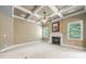 Spacious living room featuring a fireplace, neutral carpet, and coffered ceiling for added architectural detail at 8920 Ellesmere Dr, Cumming, GA 30041