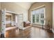 Sunlit living room features grand windows, french doors, and an upright piano at 8920 Ellesmere Dr, Cumming, GA 30041