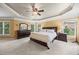 This main bedroom boasts an elegant ceiling and is complemented by a beautiful wooden dresser and matching nightstands at 8920 Ellesmere Dr, Cumming, GA 30041