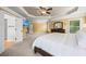 View of the expansive main bedroom showcasing plush carpeting, natural light, and a doorway leading to an en-suite bathroom at 8920 Ellesmere Dr, Cumming, GA 30041