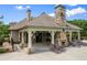 View of the community poolside lounge area with stone fireplace and ample seating at 8920 Ellesmere Dr, Cumming, GA 30041