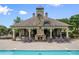 Community poolside lounge area with stone fireplace and comfortable seating at 8920 Ellesmere Dr, Cumming, GA 30041