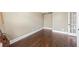 Neutral room with hardwood floors and baseboards showing versatility at 8920 Ellesmere Dr, Cumming, GA 30041
