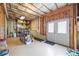 Unfinished basement with concrete walls and floor featuring exposed ductwork and a double door to the outside at 8920 Ellesmere Dr, Cumming, GA 30041
