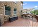 Wooden deck is furnished with seating, an umbrella, and overlooks green backyard and other homes at 8920 Ellesmere Dr, Cumming, GA 30041