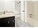 Bright bathroom featuring a vanity with black cabinets and shower over tub at 132 Bishop Nw Rd, Cartersville, GA 30121